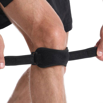 Avlastande knäband placerat under knäskålen